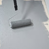 Painting Mid Grey Floor Paint Anti Slip onto a floor with a roller